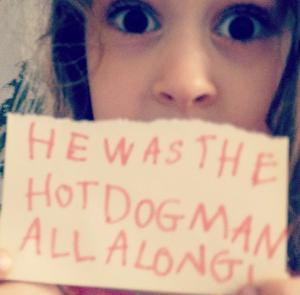 Image of kid holding a poster saying it was the hotdog man all along